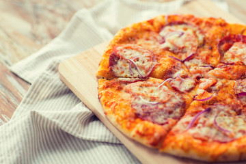 close up of homemade pizza on wooden table