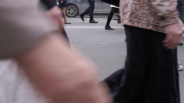 a crowd of people walking down the street 