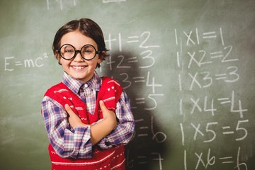 Boy standing in front of blackboard