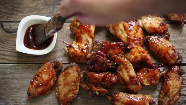 dipping with bbq sauce the chicken wings