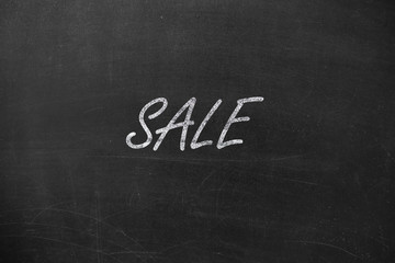 Fototapeta premium text SALE. Written in chalk on a blackboard.