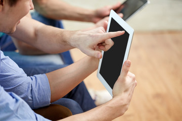 close up of happy friends with tablet pc at home