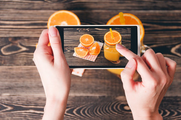 Hands Taking Photo of Oranges. Technology Concept