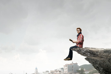 Hipster guy with book in hands