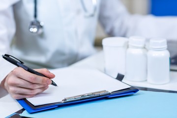 Close up of woman vet writing 
