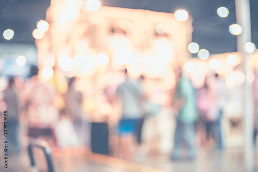 Poster blurred background,crowd of people in expo fair with bokeh light