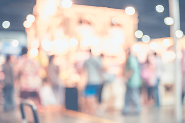 Blurred background,crowd of people in expo fair with bokeh light