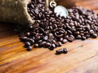 Coffee beans with bag on the wood floor