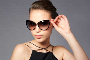 beautiful young woman in elegant black sunglasses