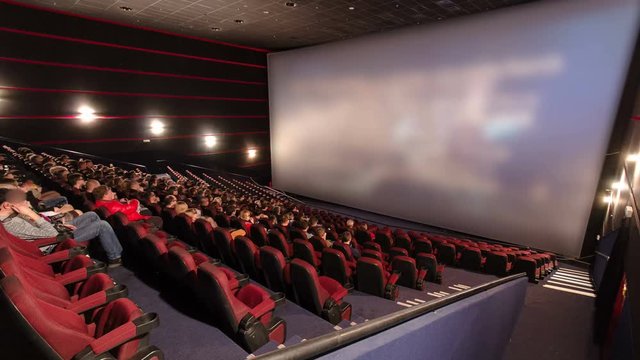 viewers watch motion picture at movie theatre timelapse