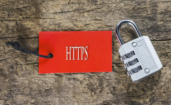 Combination number padlock on wood background with HTTPS written