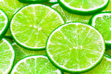 Green background with citrus-fruit of lime slices