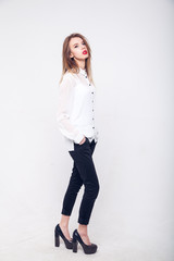 Contemporary Clothing Design. Modish Woman in White Blouse and Pants. Fashion