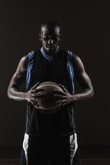 Fototapeta premium Portrait of basketball player holding a ball