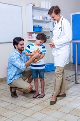 Family petting a kitten