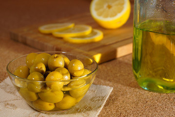 Olives, lemon and olive oil. Still life