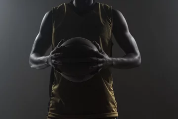 Poster Close up on basketball player holding a ball © WavebreakmediaMicro