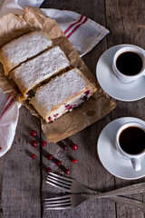 Strudel or pie with cranberries and cheese and two cups of coffee