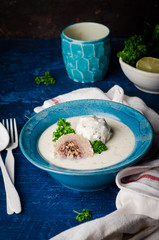 Kibbeh bil laban - arabian yogurt soup with stuffed bulgur cutletson dark background. Selective focus