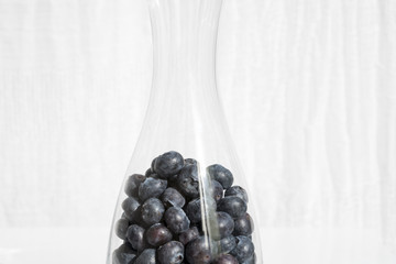 Fresh blueberries in glas bottle