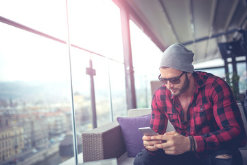 Urban man typing on smartphone