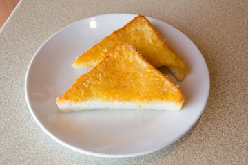 Naklejka na ściany i meble Fried triangle bread with cheese and butter