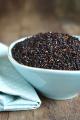 Blue ceramic bowl of black rice.