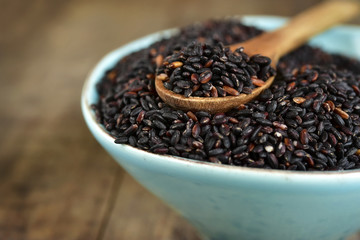 Blue ceramic bowl of black rice.