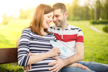 Happy couple with pregnant woman