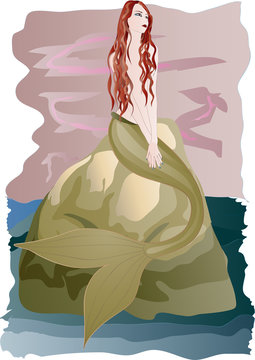 Beautiful redhead mermaid sitting on rock by the sea