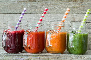 Selection of colorful vegetable juices in glass jars