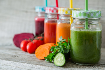 Selection of colorful vegetable juices in glass jars