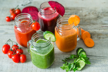 Selection of colorful vegetable juices in glass jars