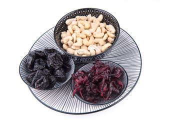 Group of plums, hibiscus and cashews