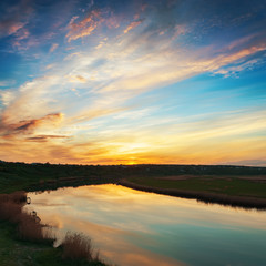 Fototapeta na wymiar clouds in sunset and river