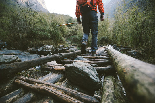 Hiker Crossing The Bridge In Himalayas
