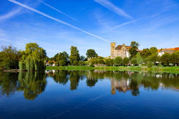 Fototapeta premium Pond in village with houses reflection in germany