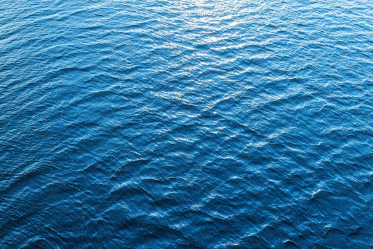 blue water as background with sun reflections
