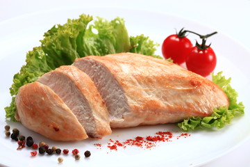 Chicken file fried isolated on white background. Chiken with lattuce and tomatoes 