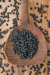 spilled black beans on a wooden spoon