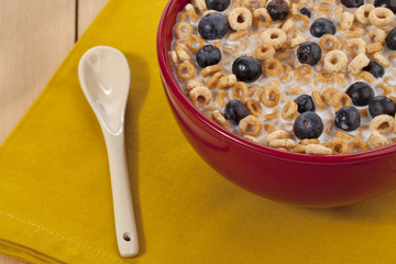cropped image of breakfast bowl with spoon on napkin.
