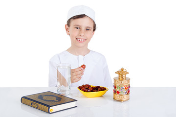 Young Muslim boy holding dates ready for brakfast in Ramadan