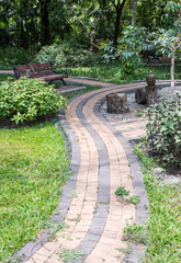 Block tile walkway with wooden bench