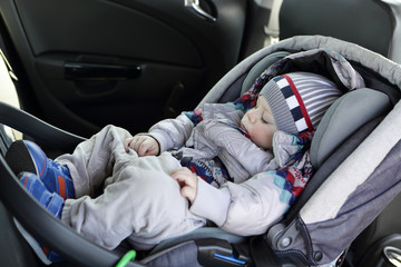 Child sleeping in baby car seat