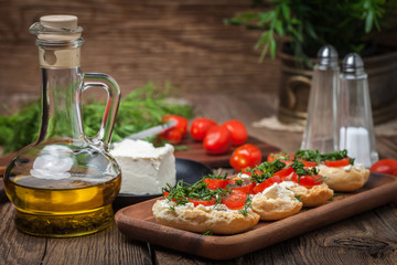 Delicious bruschetta with tomatoes, feta cheese, dill and spice