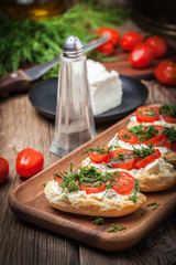 Delicious bruschetta with tomatoes, feta cheese, dill and spice