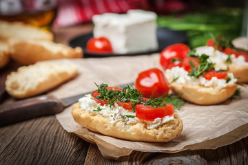 Delicious bruschetta with tomatoes, feta cheese, dill and spice
