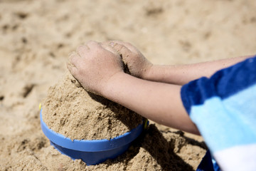 hands boy playing with sand