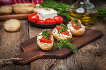 Delicious bruschetta with tomatoes, feta cheese, dill and spice