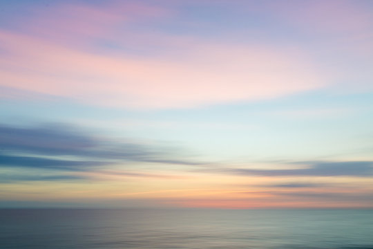 Blurred defocused sunset sky and ocean nature background.